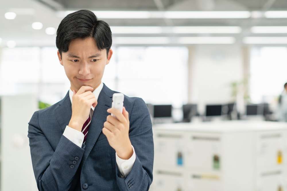 アルコールチェッカーを見て考える人