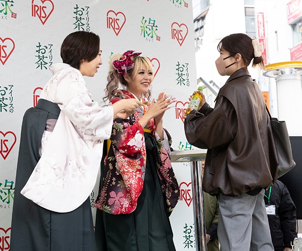 一般客に「アイリスのお茶 綠（りょく）」を手渡しするEXITとエルフ